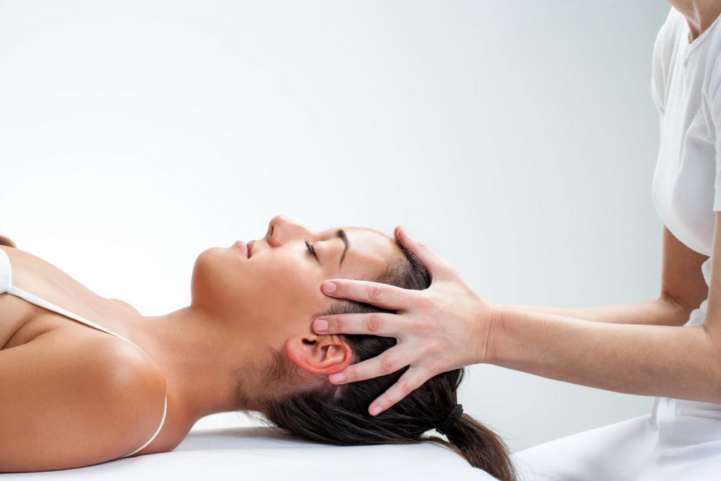 woman receiving a osteopathic head massage