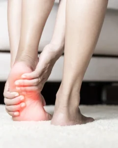 A woman with plantar fasciitis pain in her left foot